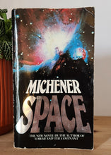 Load image into Gallery viewer, Book titled 'Space' by Michener on a wooden shelf with a plant and orange object in the foreground.
