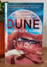 Load image into Gallery viewer, Book titled 'Dune: The Battle of Corrin' on a wooden surface with a plant in the foreground.

