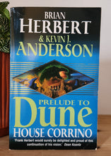 Load image into Gallery viewer, Book titled 'Prelude to Dune' by Brian Herbert and Kevin J. Anderson on a wooden surface with a plant in the foreground.
